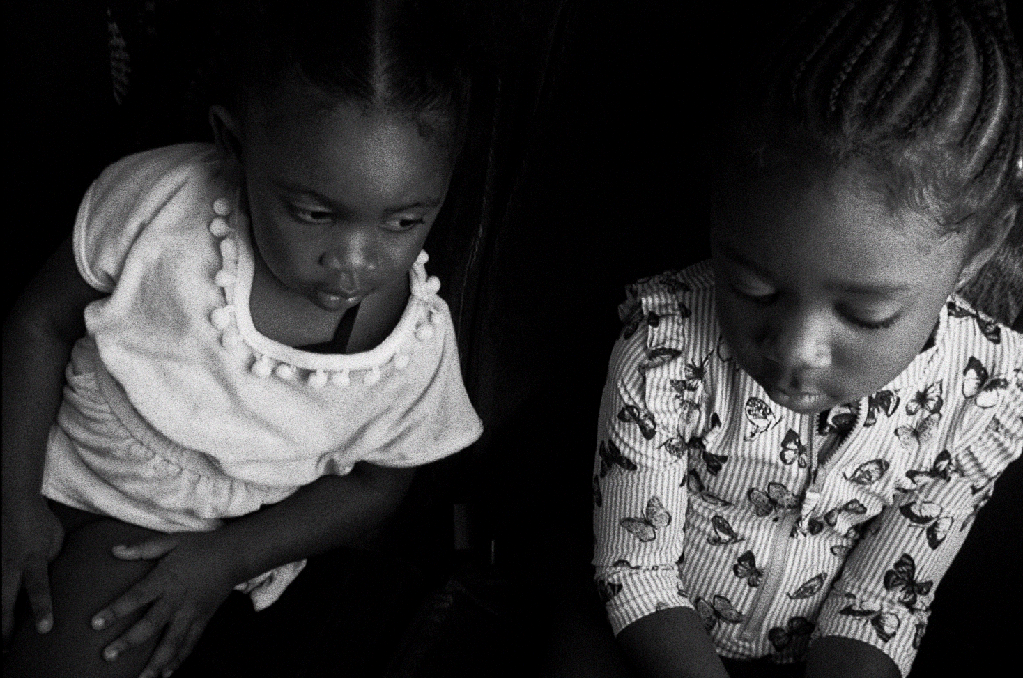 Two young girls sitting on a bus